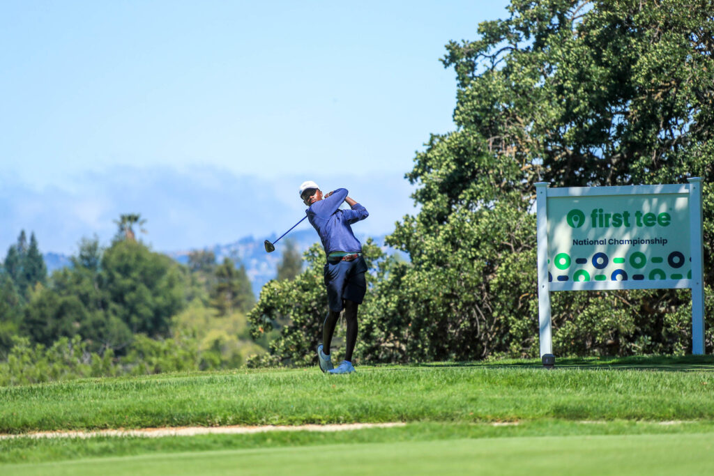 young man swinging golf club and having fun on an affordable golf course